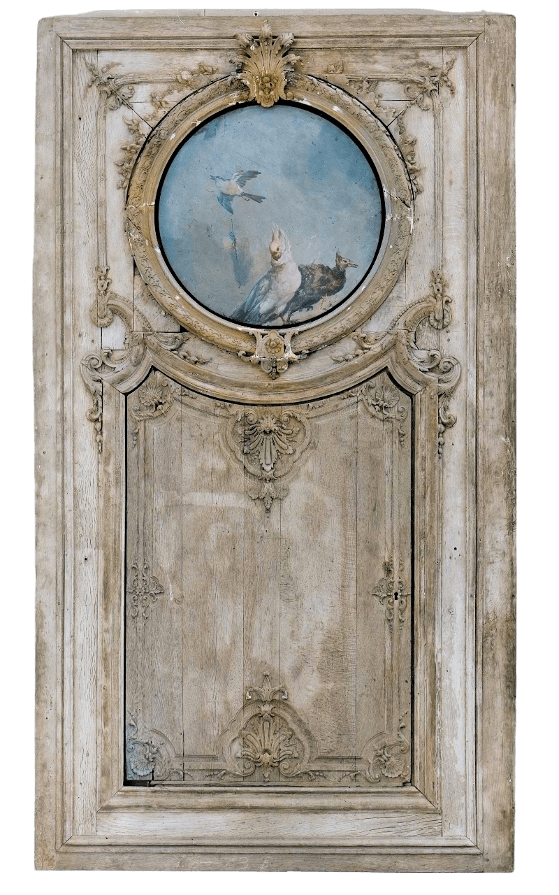 a photo of an old door, with a circular painting of birds above the lock